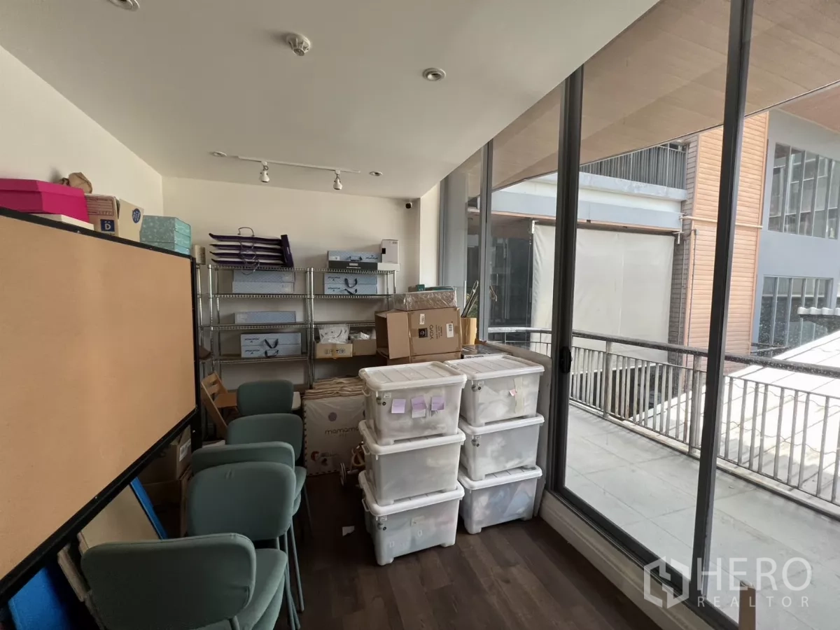 Retail Space for rent in Watthana, Bangkok - Storage room with floor-to-ceiling windows opening to a balcony corridor.