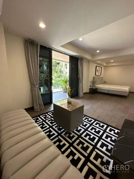 Detached House for rent in Suan Luang, Bangkok - Ground-floor living area opening to garden patio through sliding doors.