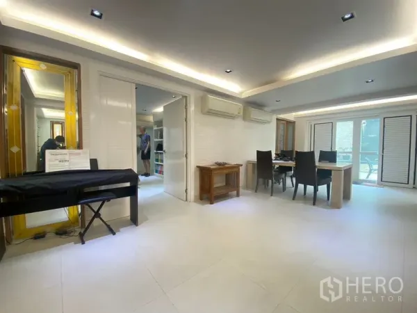 Detached House for sale in Khlong Toei, Bangkok - Dining space with table and chairs, piano keyboard, and doors to the terrace.
