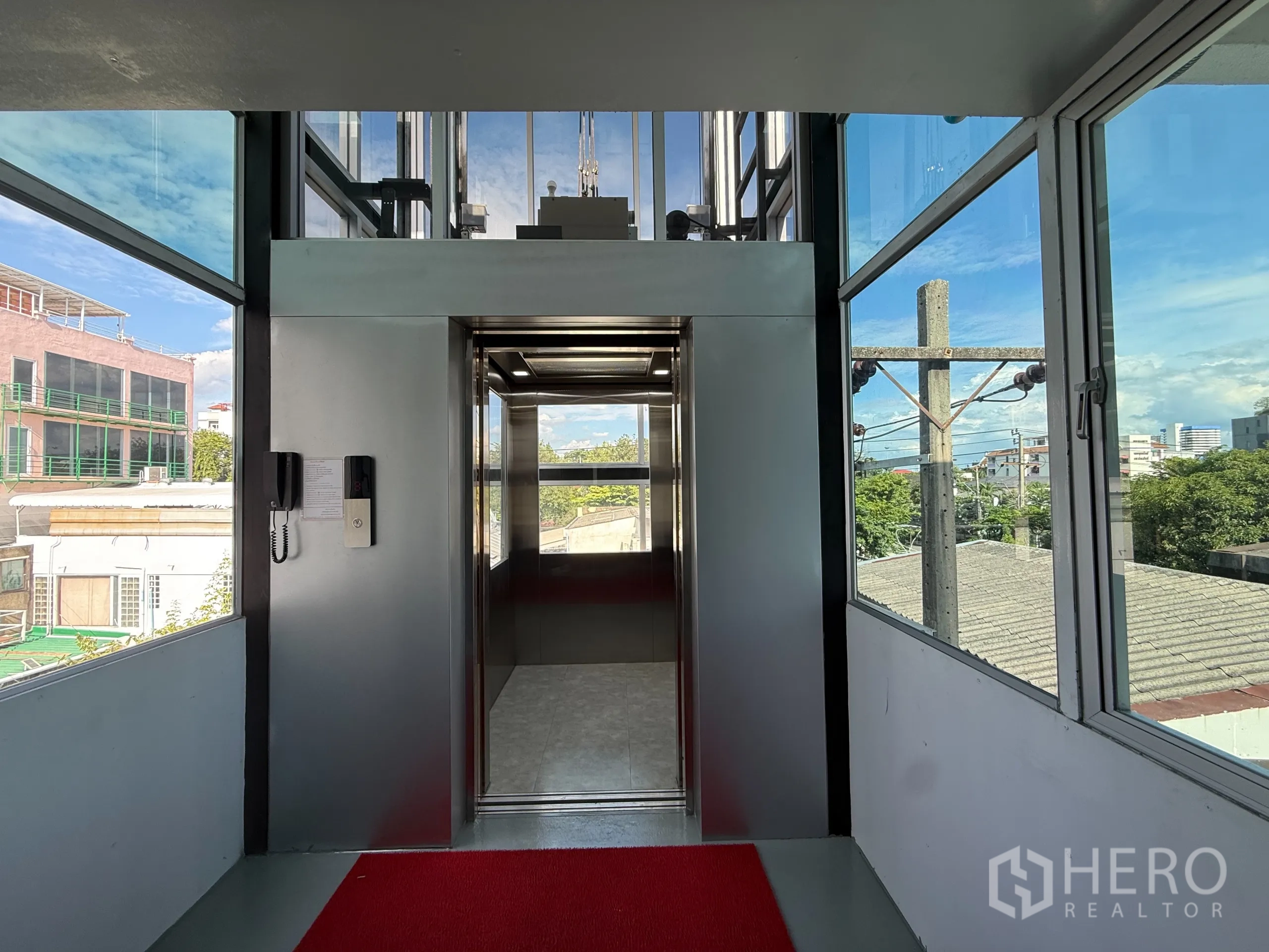 Office Space for rent in Wang Thonglang, Bangkok - Private elevator lobby enclosed in glass with city views.