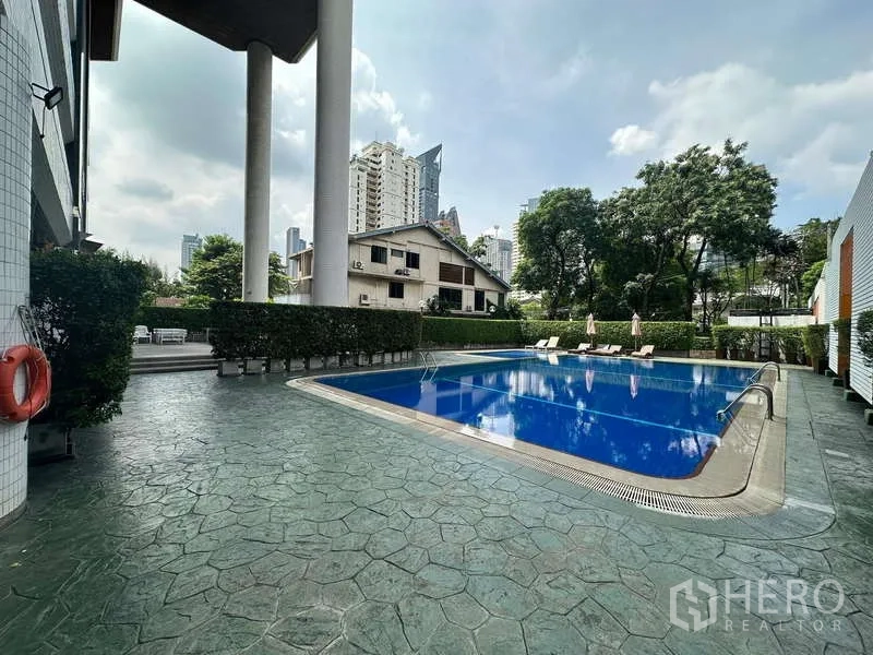 คอนโด ให้เช่าในWatthana, Bangkok - สระว่ายน้ำกลางแจ้งของคอนโด พร้อมเก้าอี้อาบแดด รายล้อมด้วยสวน