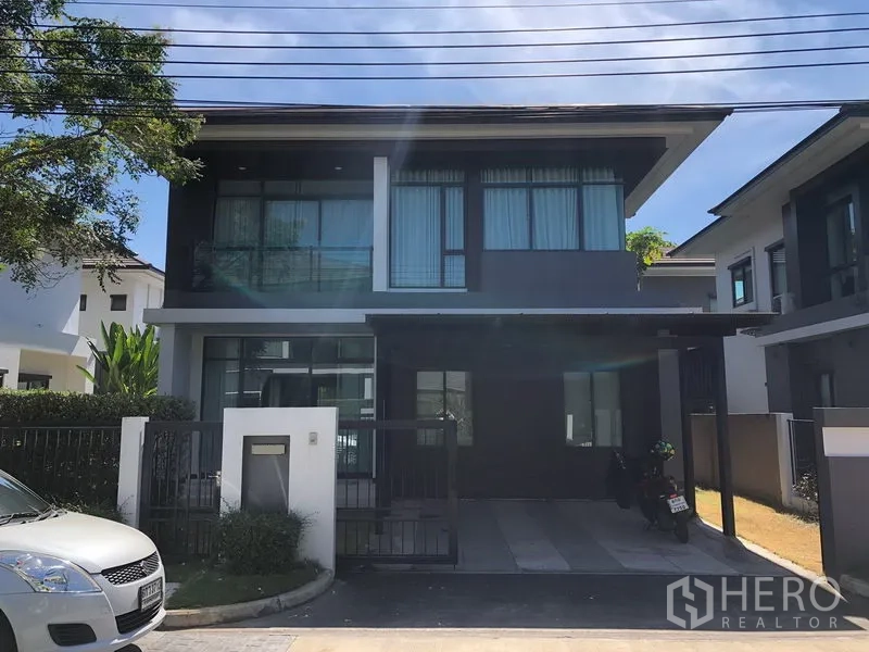 Detached House for rent or sale in Bang Kapi, Bangkok - Two-storey modern detached house exterior with covered parking and gated entrance in Setthasiri Krungthep Kreetha.