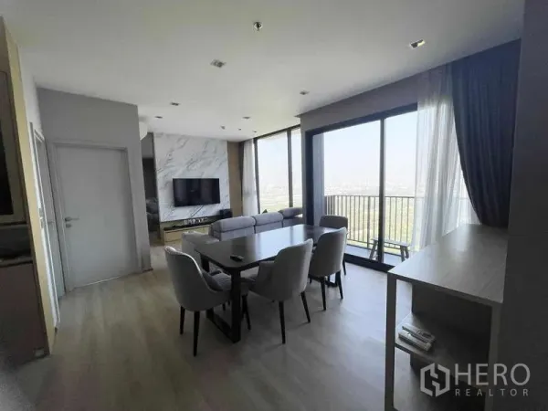 Condominium for rent - Bright dining-living area with balcony and expansive glazing capturing park views.