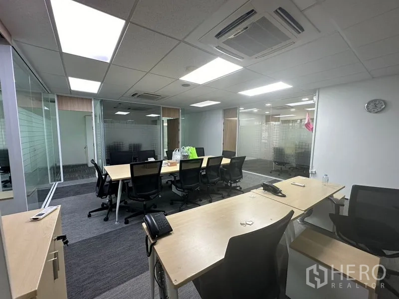 Office Space for rent - Workstation zone with conference table, cassette air-conditioning, and frosted glass meeting rooms.