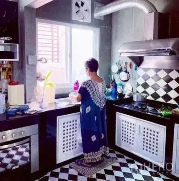 Detached House for sale in Khan Na Yao, Bangkok - Modern kitchen with black-and-white checkered tiles, window ventilation, and stainless range hood.