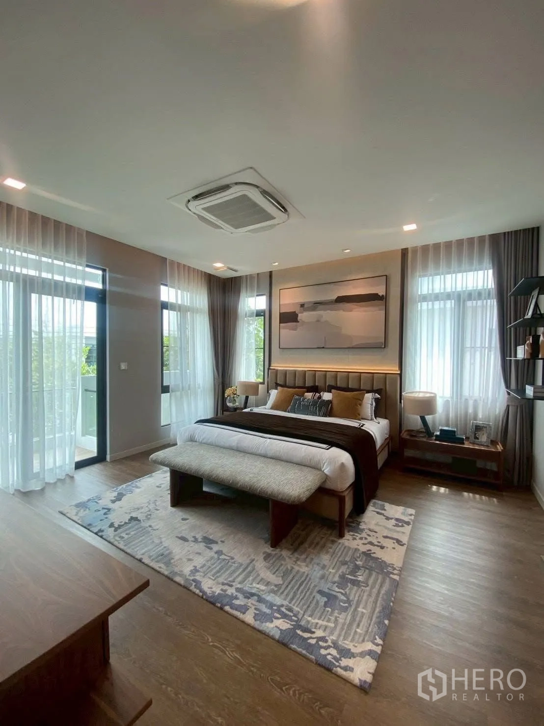 Detached House for rent in Bang Phli, Samut Prakan - Large master bedroom with king bed, bench and floor-to-ceiling windows.