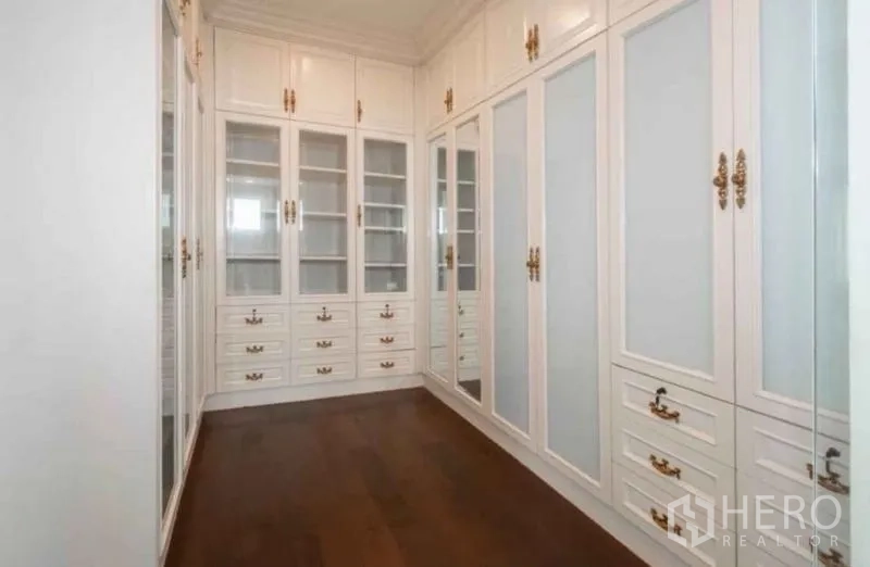 Detached House for rent or sale in Bang Phli, Samut Prakan - Walk-in closet with custom white built-in wardrobes and wood flooring.