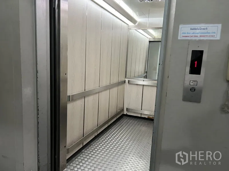 Office Space for rent in Mueang Samut Prakan, Samut Prakan - Passenger elevator interior with stainless handrails and patterned metal floor.