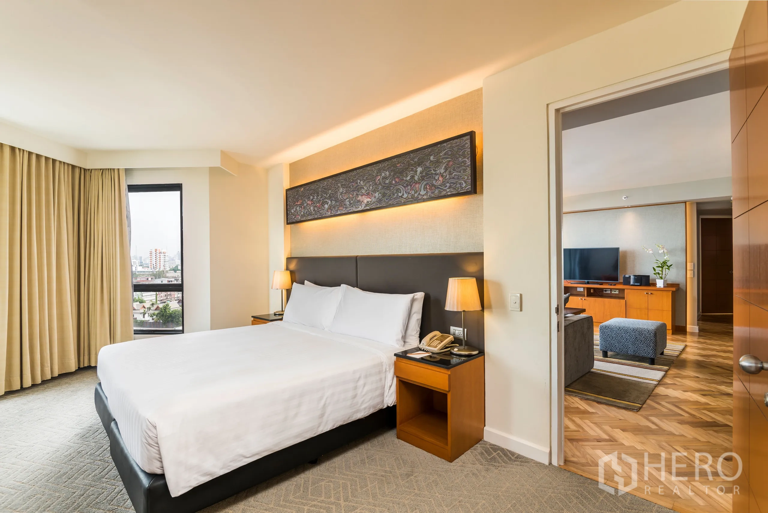 Condominium for rent in Yan Nawa, Bangkok - Second bedroom with king bed near the living room, built-ins and a city-view window.