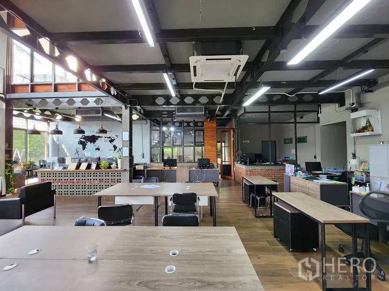 Home Office for rent in Mueang Nonthaburi, Nonthaburi - Open-plan office area with exposed beams, pendant lights and multiple workstations.