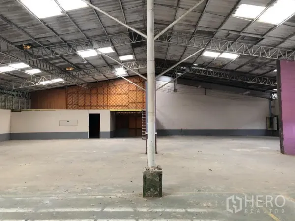Warehouse for rent in Sai Mai, Bangkok - Open-plan storage area with high ceiling, mezzanine room, and ladder inside the warehouse.