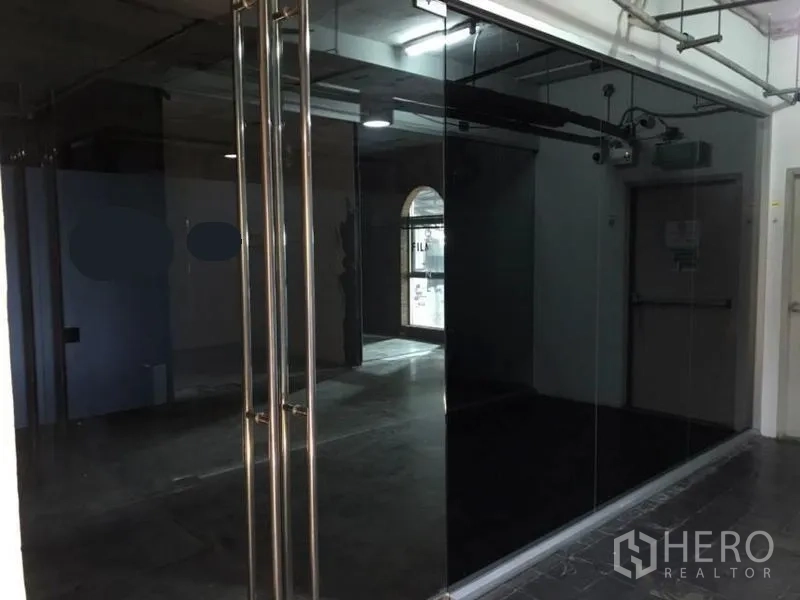 Office Space for rent in Watthana, Bangkok - Glass-fronted office entrance with double doors and exposed ceiling.