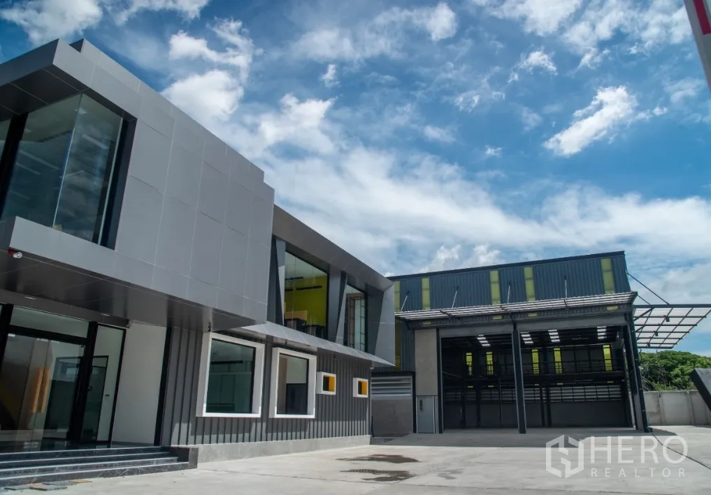 Warehouse for sale in Bang Khen, Bangkok - Modern office building beside high‑ceiling warehouse with spacious loading yard.