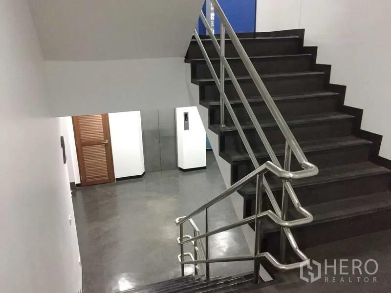 Office Space for rent in Khlong Toei, Bangkok - Internal staircase with stainless-steel handrails leading to the corridor and lift lobby.