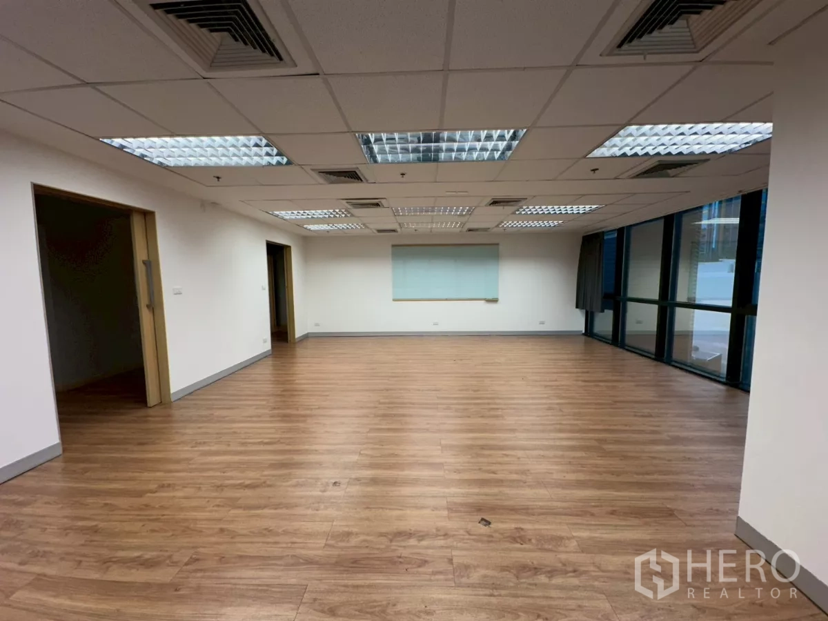 Office Space for rent in Khlong Toei, Bangkok - Open plan office space with abundant natural light and wooden flooring.