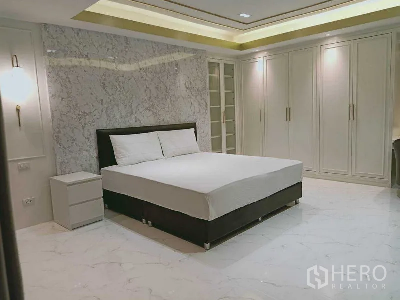 Condominium for  in Watthana, Bangkok - Second view of bedroom showing wardrobes and marble flooring.