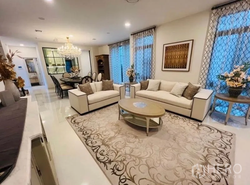 Detached House for rent or sale in Saphan Sung, Bangkok - Elegant lounge with twin sofas, coffee table and patterned curtains.