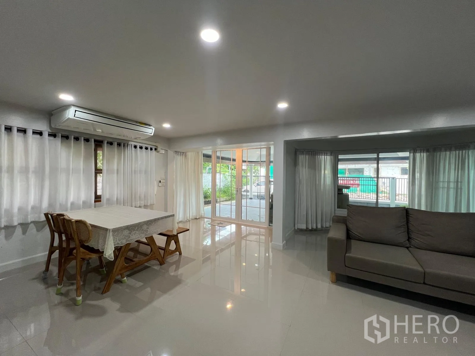Detached House for rent in Saphan Sung, Bangkok - Dining corner with table and chairs beside large windows and glass doors to the carport.