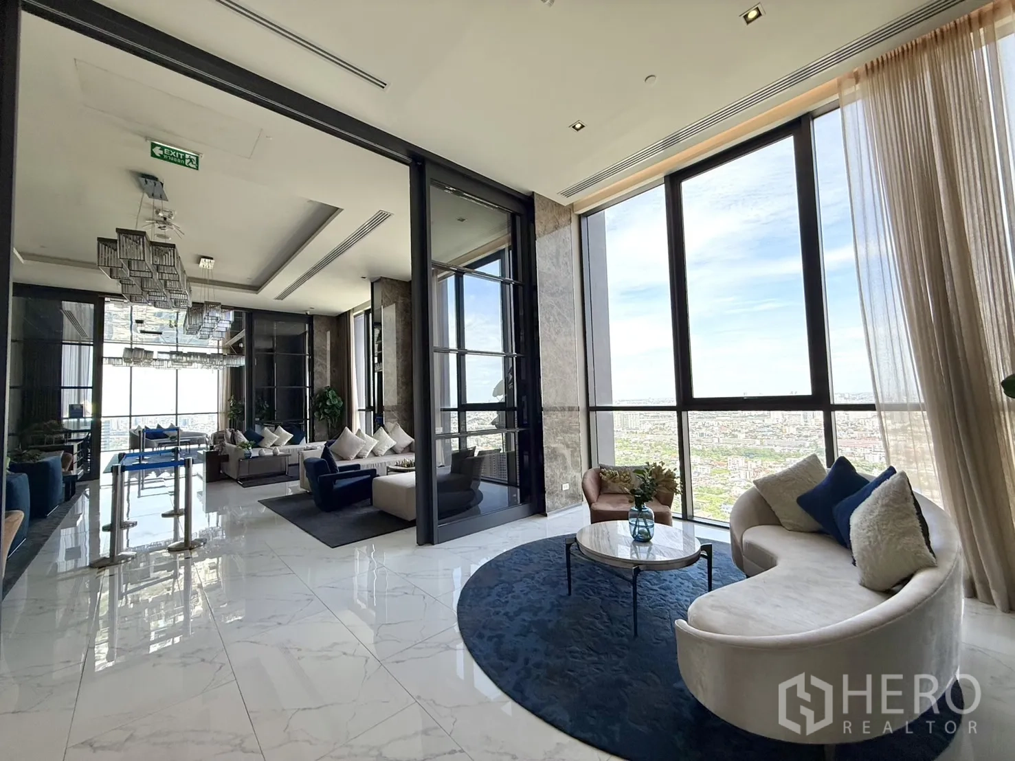Condominium for sale in Chatuchak, Bangkok - Sky lounge with marble floors, plush seating, and sweeping skyline.