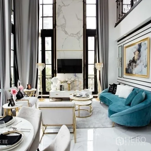 Townhouse for sale - Bright lounge with floor-to-ceiling windows, marble feature wall with TV and adjacent dining nook.