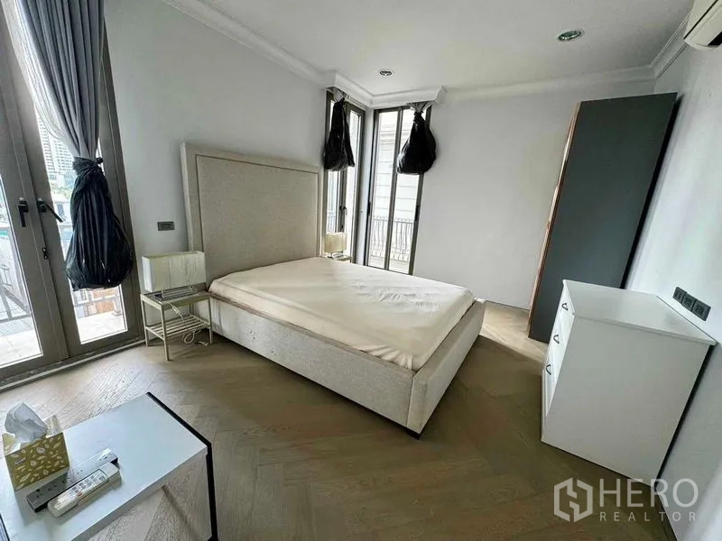 ทาวน์เฮาส์ ให้เช่าในWatthana, Bangkok - ห้องนอนสว่าง มีหน้าต่างมุมและประตูระเบียง เฟอร์นิเจอร์มินิมอล.