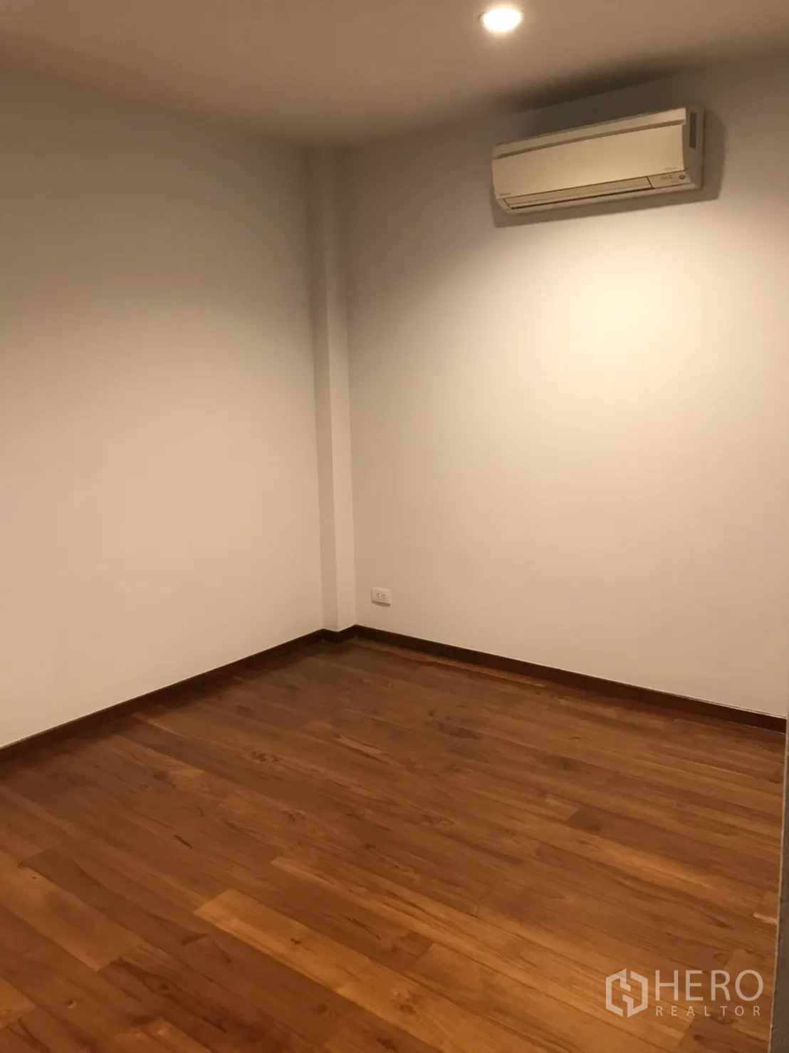 Detached House for rent in Wang Thonglang, Bangkok - Empty room with wood floors and wall-mounted air conditioner, ideal for office
