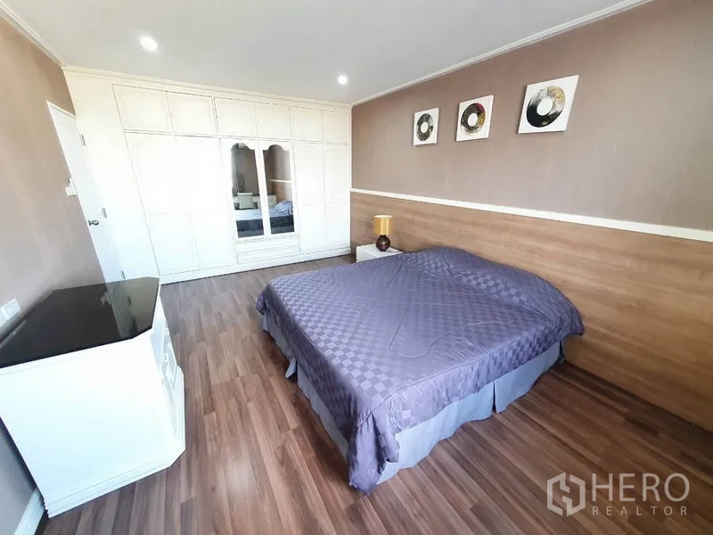 Condominium for rent in Watthana, Bangkok - Second bedroom with large built-in wardrobe and wood floors.
