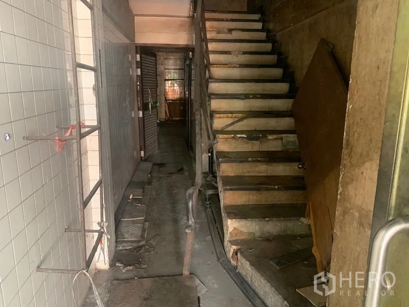 อาคารพาณิชย์ ให้เช่าในWatthana, Bangkok - ทางเดินแคบพร้อมบันไดไม้และส่วนด้านหลังแบบประตูม้วน