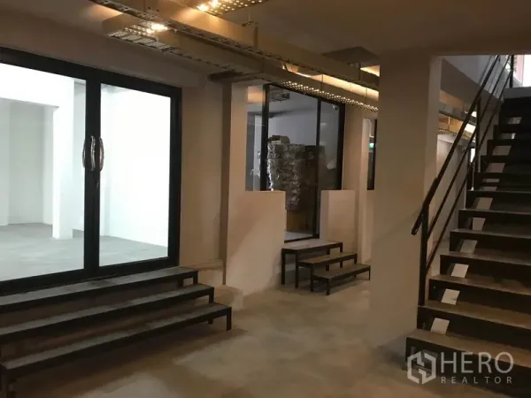 Office Space for rent in Watthana, Bangkok - Lobby space with a metal staircase, glass partitions and multi-step access to offices.