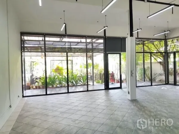 办公空间 出租在Chatuchak, Bangkok - 宽敞办公室大厅，通高窗户面向绿意庭院。