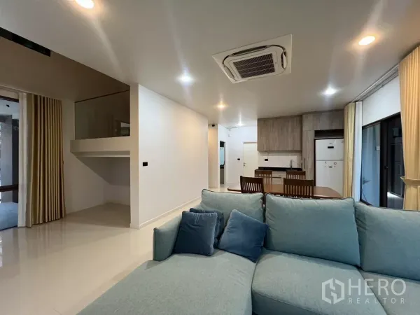 Detached House for rent or sale in Bang Kapi, Bangkok - Living room view toward the pantry and dining set under recessed lighting
