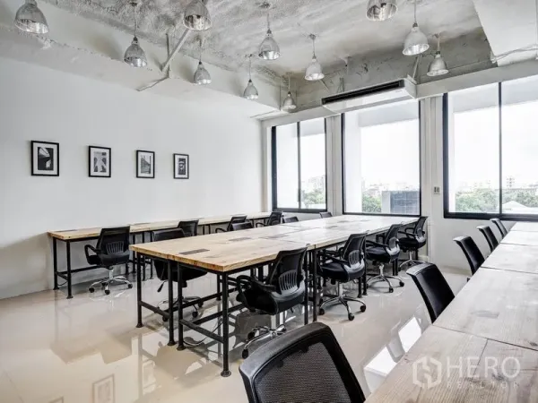 Office Space for rent in Khlong Toei, Bangkok - Open-plan workspace featuring conference-length tables, polished floors and floor-to-ceiling windows with city views.