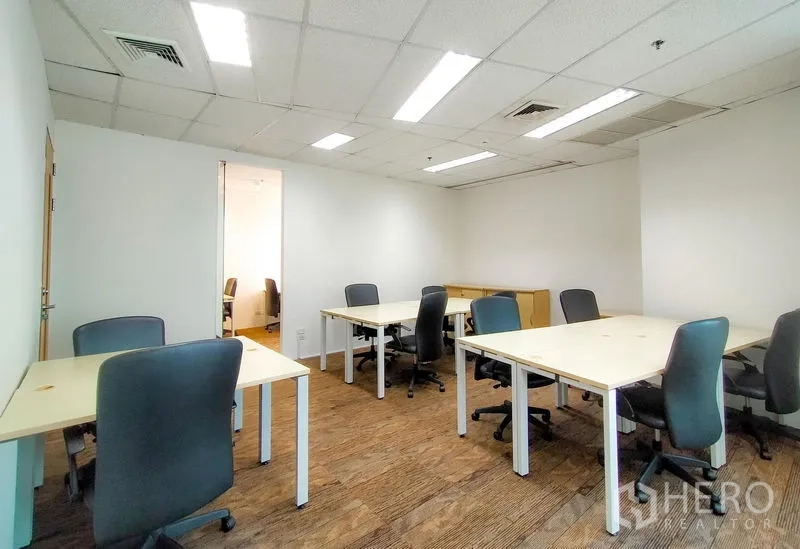 Office Space for rent in Khlong Toei, Bangkok - Private team room with multiple desks, office chairs and bright ceiling lights.