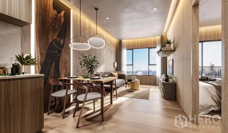 Condominium for sale in Khlong Toei, Bangkok - Open-plan kitchen, dining, and living area with wood finishes, pendant lights, and city-facing windows.