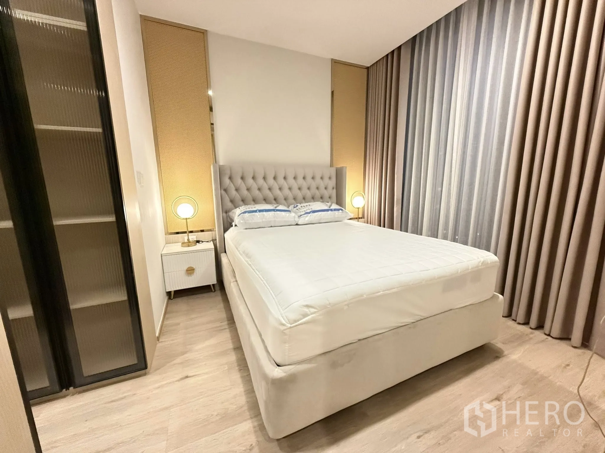 公寓 for rent in Watthana, Bangkok - 卧室另一视角，可见床、落地窗帘与玻璃移门衣柜。