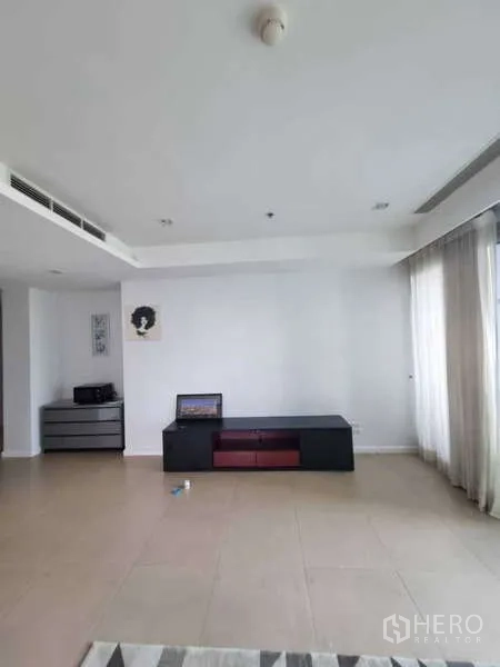 คอนโด ให้เช่าหรือขายในKhlong San, Bangkok - ผนังโล่งกว้างพร้อมชั้นวางทีวีและผ้าม่านโปร่งในพื้นที่นั่งเล่น