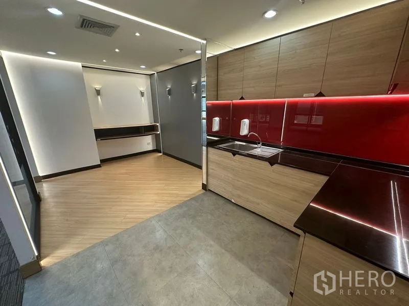 Office Space for rent in Khlong Toei, Bangkok - Pantry with modern wood cabinetry, red backsplash and LED lighting.