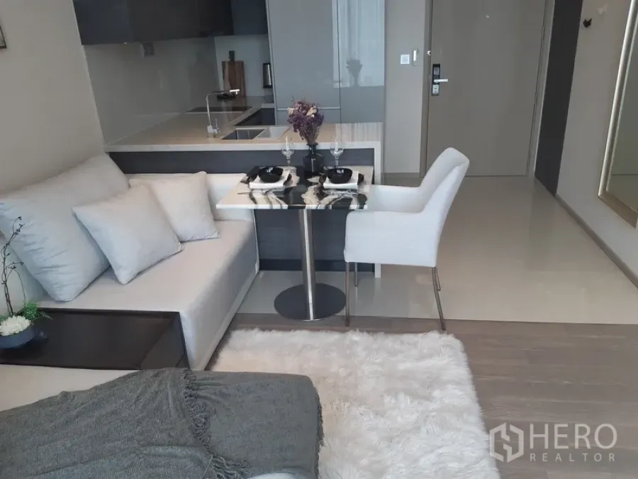 คอนโด ให้เช่าหรือขายในWatthana, Bangkok - มุมทานอาหารสำหรับสองที่ข้างโซฟา เชื่อมต่อครัวแบบเปิดผนังกระจกเงา