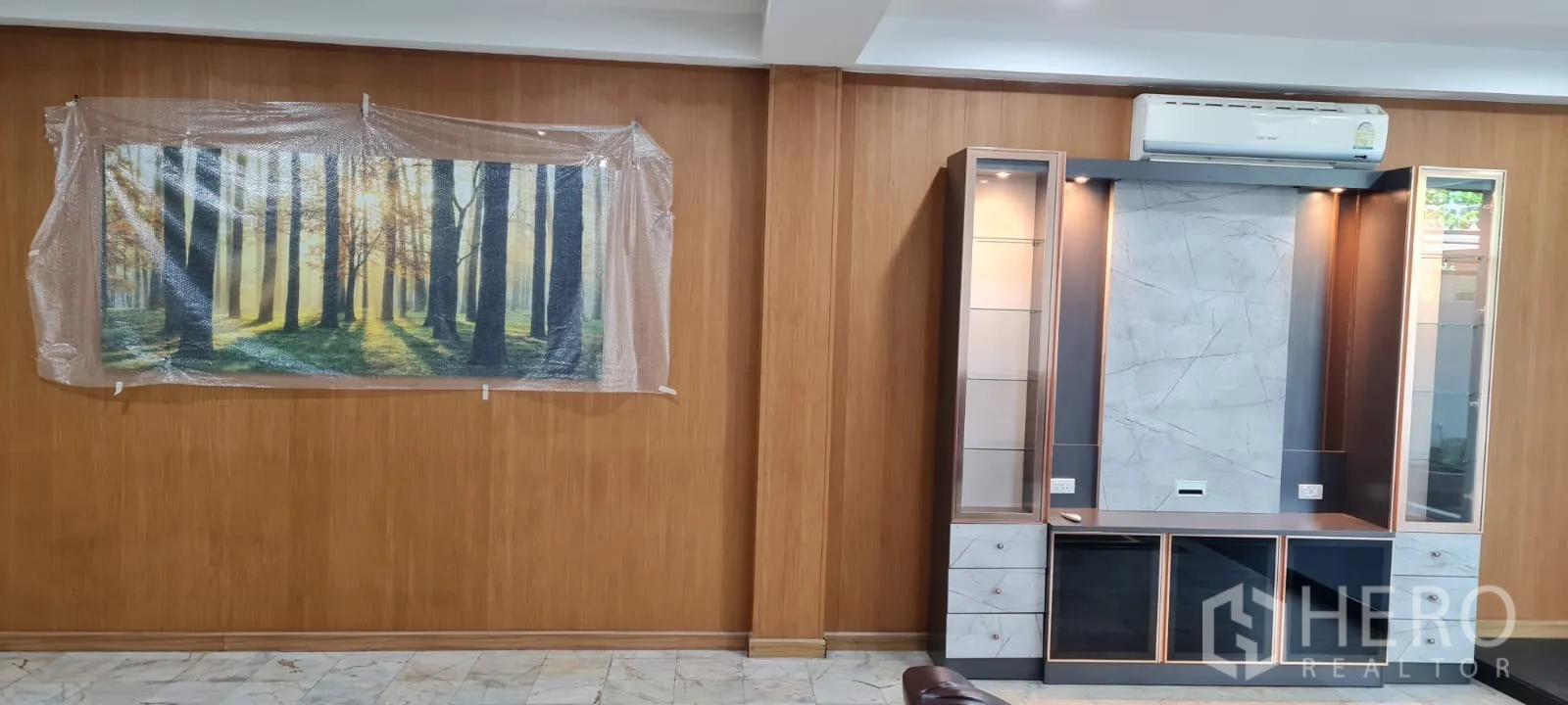 Home Office for rent - Wood‑paneled wall with media cabinet and framed forest artwork