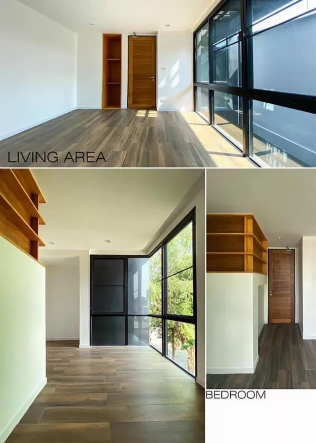 Detached House for rent in Huai Khwang, Bangkok - Sunlit living and bedroom with wide windows, wood floors and built‑in shelving.