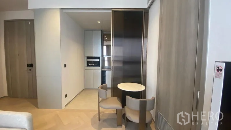 Condominium for rent - Compact dining corner beside open kitchen with round table and two chairs.