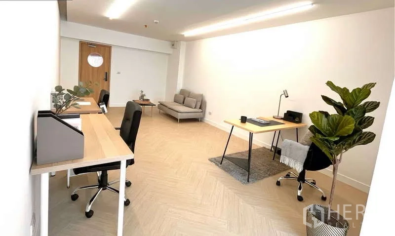 Office Space for rent in Watthana, Bangkok - Minimalist office with workstations along both walls, indoor plant, and task lighting.