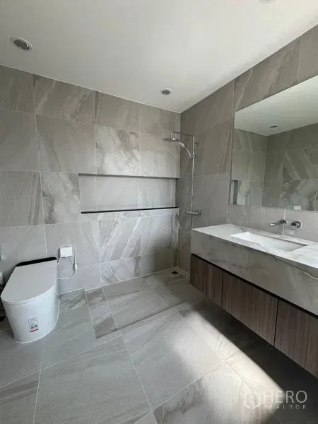 Townhouse for rent - Contemporary gray-tiled bathroom with walk-in shower and floating vanity.