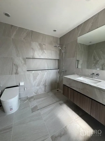 Townhouse for rent - Contemporary gray-tiled bathroom with walk-in shower and floating vanity.
