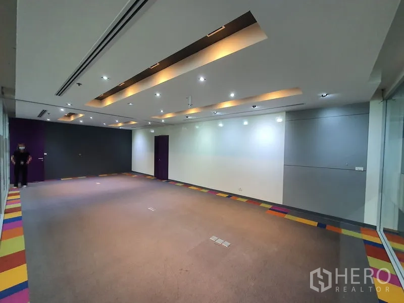 Office Space for rent in Watthana, Bangkok - Spacious conference room with recessed strip lighting and carpet flooring.