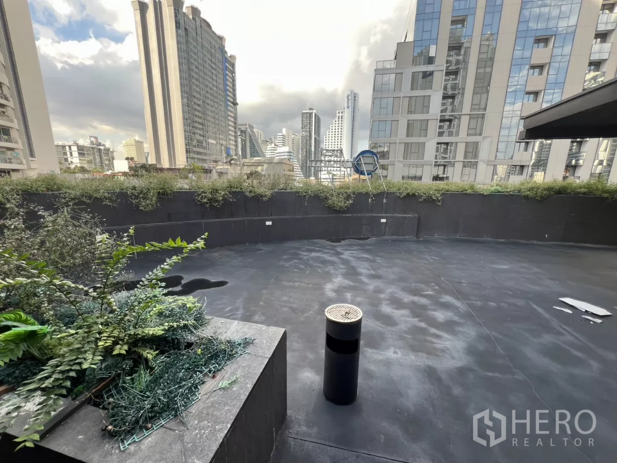 Retail Space for rent - Large outdoor terrace with city skyline views and planter beds.