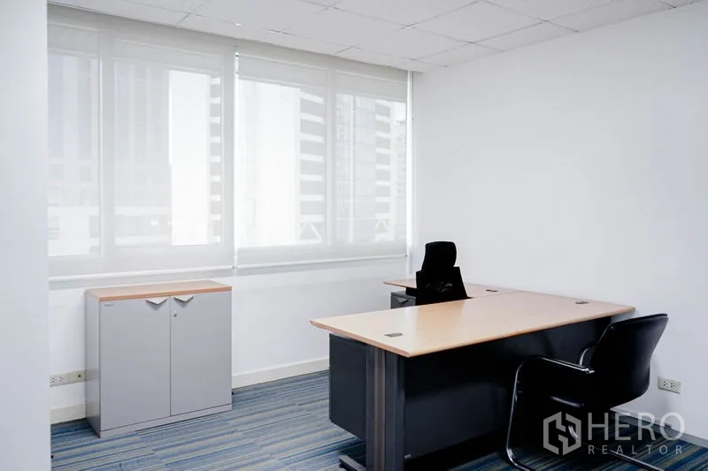 Office Space for rent in Watthana, Bangkok - Private manager’s office with desk, chair and window blinds.