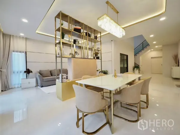Detached House for rent in Bang Phli, Samut Prakan - View from dining to lounge with feature display shelf and staircase in a luxe neutral palette.