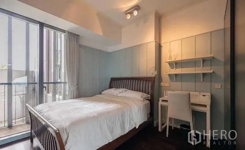 Condominium for rent - Guest bedroom with desk and sliding glass door to the balcony.