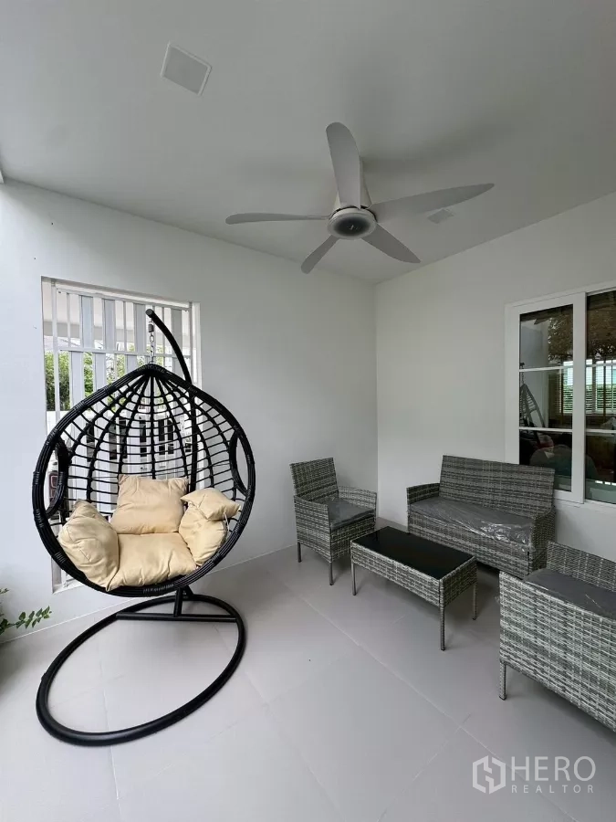 Detached House for rent in Bang Phli, Samut Prakan - Shaded terrace with ceiling fan, rattan seating set and a hanging egg chair